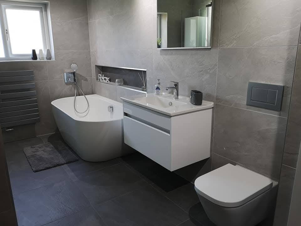 Finished master bathroom with freestanding bath, walk-in shower and large-format slate-effect tile