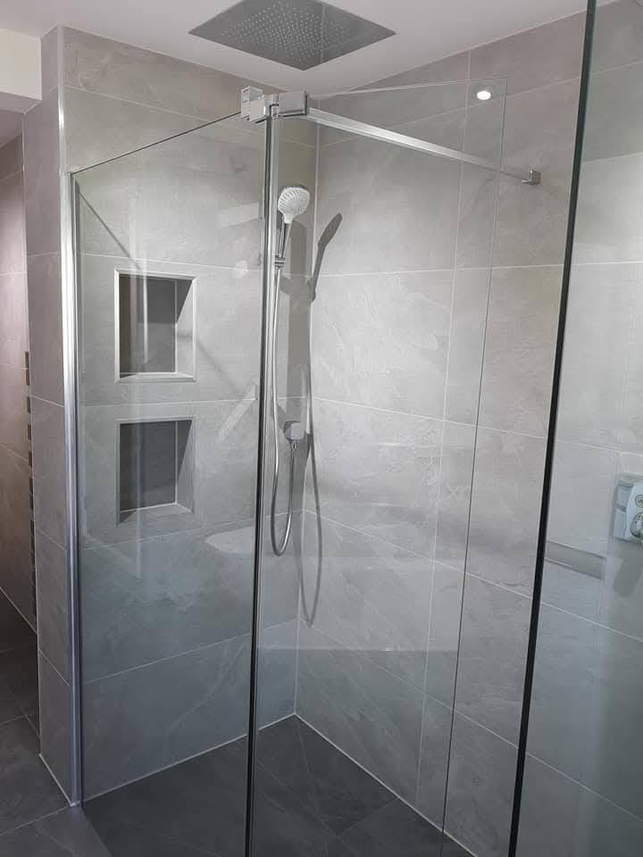 Walk-in shower with chrome thermostatic valve and large-format slate-effect tile installed by DW Plumbing & Heating Yorkshire