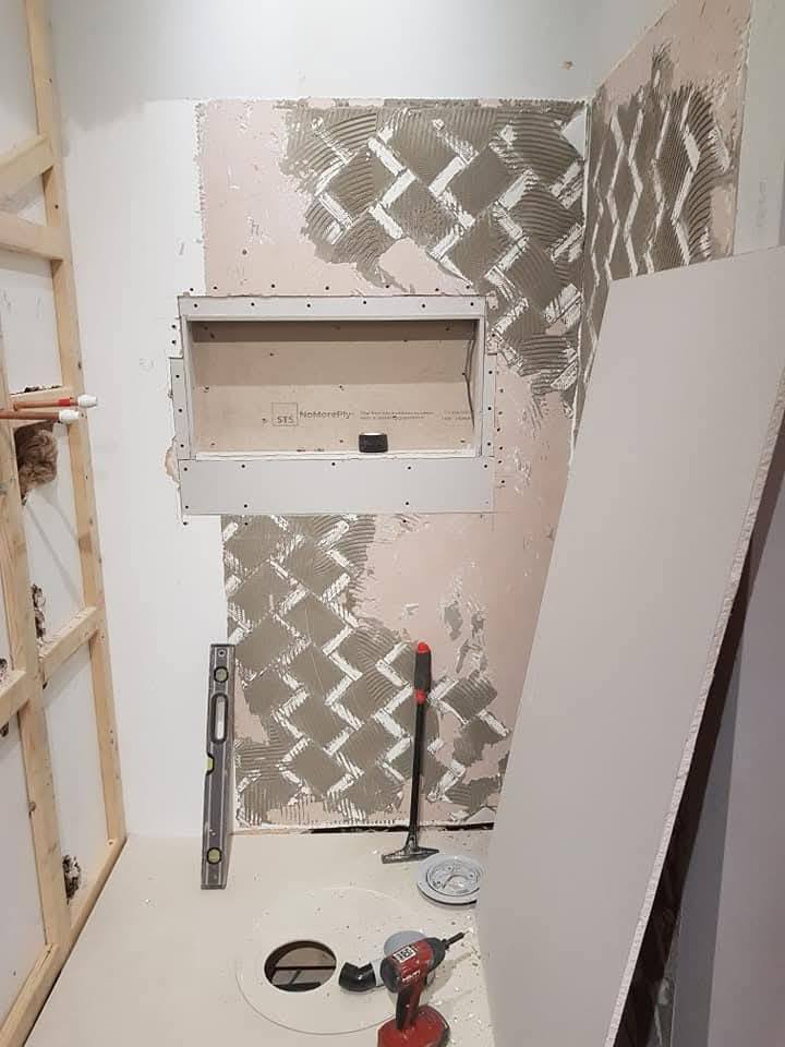 Walls prepped with tile adhesive and aqua-board, niche cut in for backlit feature